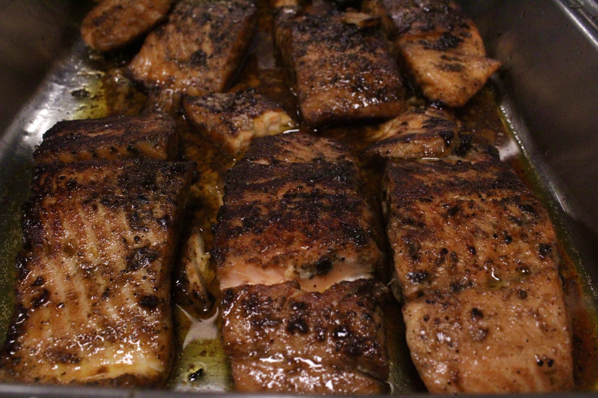 Jerk salmon pieces in a pan